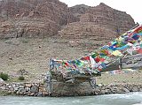 Tibet Kailash 08 Kora 11 Bridge Over Lha Chu Towards Chuku Gompa The Mount Kailash kora is 52km in length, crosses the 5630m Dlma La and normally takes three days. There were no yaks available at Darchen, so our cook Paldi and porter Pemba Rinji agreed to be yaks and carry our gear. They were also paid the yak rate, about 80 yuan a day. After leaving Tarboche, we walked for just 30 minutes and reached a small bridge (4710m) across the Lha Chu (Divine River) with the trail to Chuku Gompa beyond.